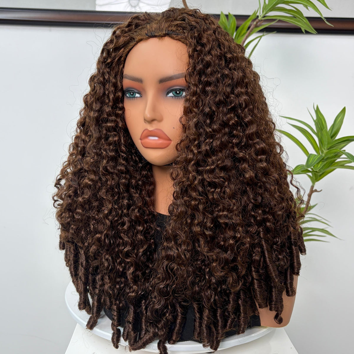 Perruque Olahair longue et bouclée brun chocolat sur tête de mannequin avec des boucles serrées et volumineuses